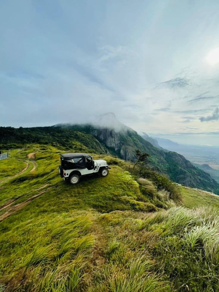 The Ridge, Kerala — Cloud spilling over the peak, and the whole plain below.